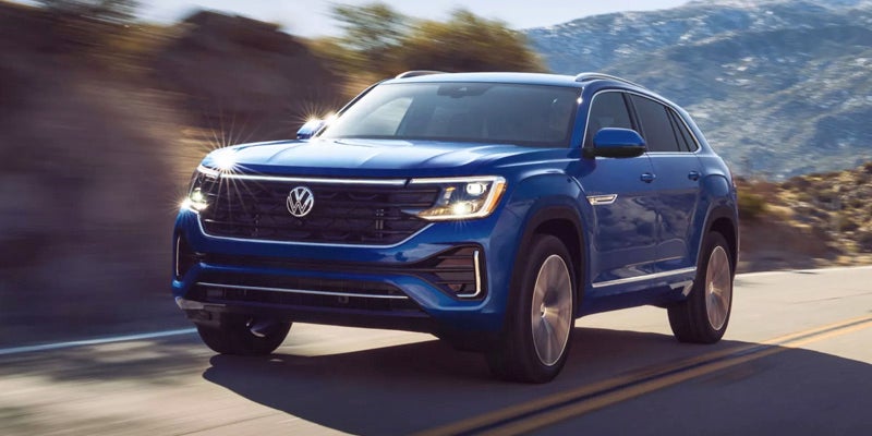 2026 Volkswagen Atlas driving on the road in Rogers, A