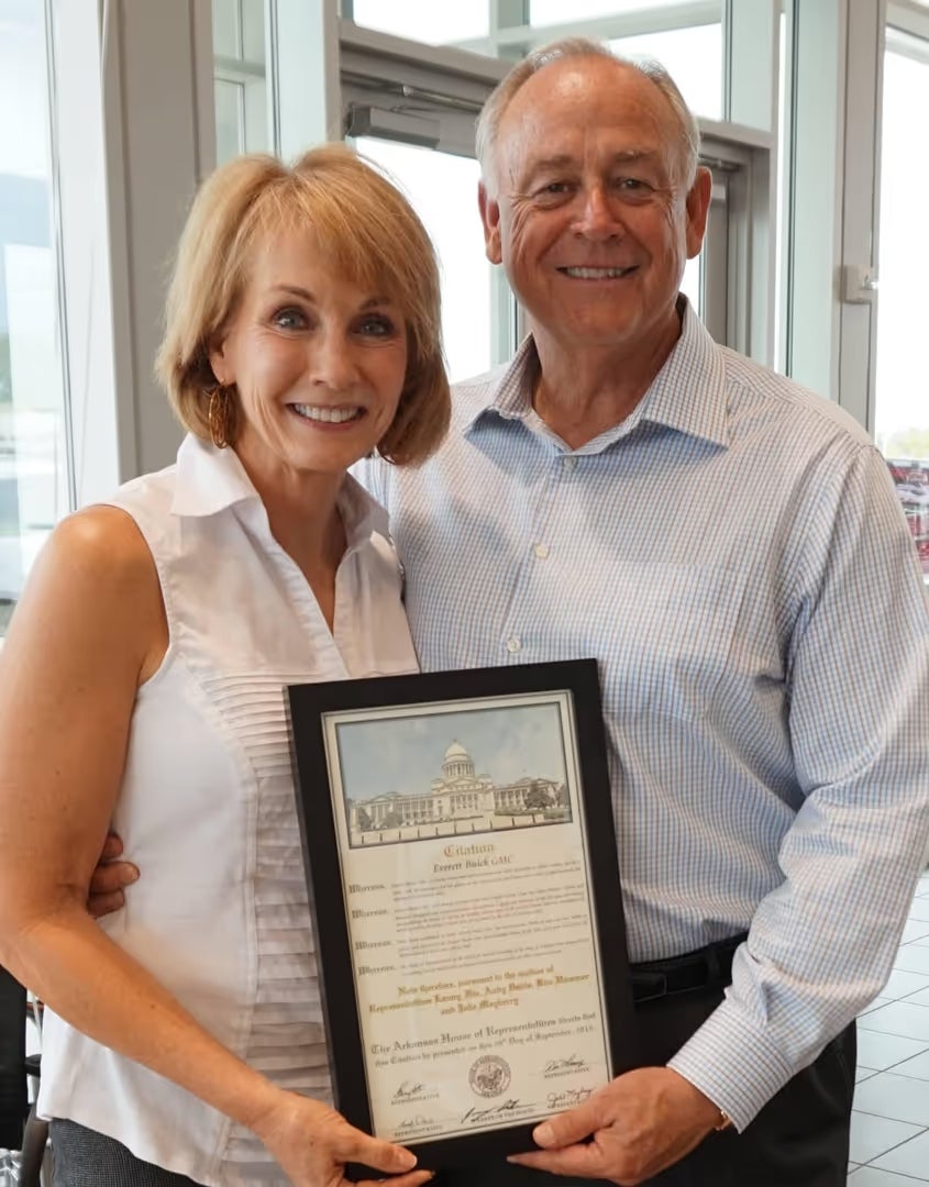 Owners of Everett Volkswagen of Rogers standing together.